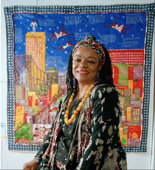 Faith Ringgold in front of her quilt Tar Beach 1993