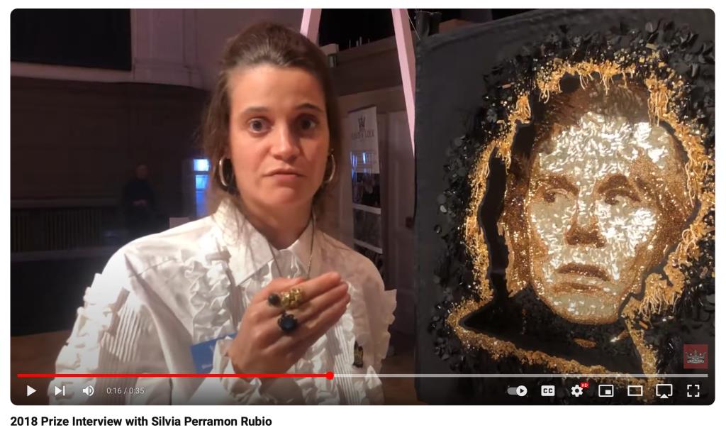 Silvia discussing her Hand & Lock first place prize on YouTube of Andy Warhol created with layers of embroidered seed beads, paillettes and sequins, all done on a Tambour frame. (Video credit: YouTube)