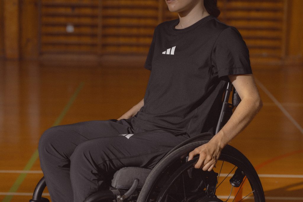 Image of man in wheelchair wearing Adidas universal training team wear