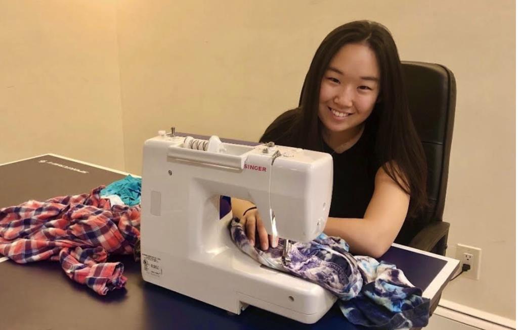 Cornell Student shown at sewing machine